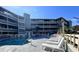 Condo pool with inviting lounge chairs and community amenities for relaxing in style at 1101 Possum Trot Rd. # B302, North Myrtle Beach, SC 29582