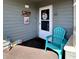 Cozy front porch with a teal chair, welcome decor, and apartment number B302 at 1101 Possum Trot Rd. # B302, North Myrtle Beach, SC 29582