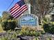 Golf Glenn Villas street sign surrounded by flowers at 1101 Possum Trot Rd. # B302, North Myrtle Beach, SC 29582