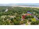 Aerial view of a waterfront property surrounded by lush greenery, showcasing the home's serene and private location at 244 George Washington Trail, Georgetown, SC 29440