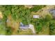 Overhead view of the property featuring a house with a long driveway, a storage shed, and a yard with mature landscaping at 244 George Washington Trail, Georgetown, SC 29440