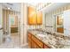 Bathroom featuring decorative wallpaper, vanity, granite countertop, lighting, and storage at 244 George Washington Trail, Georgetown, SC 29440