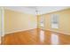 Spacious bedroom featuring hardwood floors, ceiling fan, and natural light from two windows at 244 George Washington Trail, Georgetown, SC 29440