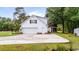 Exterior showcasing a two-story home with white siding, an attached two-car garage, and well-manicured lawn at 244 George Washington Trail, Georgetown, SC 29440