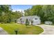A home with a well-manicured lawn, featuring a two-car garage, a shed, and mature landscaping at 244 George Washington Trail, Georgetown, SC 29440
