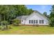 Charming home with a white exterior, well-kept lawn, complemented by a pergola and mature landscaping at 244 George Washington Trail, Georgetown, SC 29440