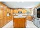 Well-equipped kitchen with an island, wooden cabinets, and stainless steel appliances at 244 George Washington Trail, Georgetown, SC 29440