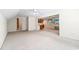 Open living area with neutral carpet, TV, and kitchenette with wooden cabinets at 244 George Washington Trail, Georgetown, SC 29440