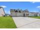 Charming home featuring a three-car garage, covered porch, and well-manicured lawn at 3344 Little Bay Dr., Conway, SC 29526