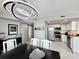 Open concept living space with a modern chandelier, dining table, and kitchen area at 107 S Ocean Blvd. # 808, Myrtle Beach, SC 29577