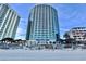View of condo building from the beach featuring blue glass balconies and ocean views at 107 S Ocean Blvd. # 808, Myrtle Beach, SC 29577