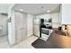 Compact kitchen design with stainless steel appliances, white cabinets, and dark countertops at 107 S Ocean Blvd. # 808, Myrtle Beach, SC 29577