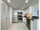 Modern kitchen featuring stainless steel appliances, white cabinetry, and dark countertops at 107 S Ocean Blvd. # 808, Myrtle Beach, SC 29577
