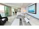 Open living area with modern furnishings and view of the dining room and the balcony at 107 S Ocean Blvd. # 808, Myrtle Beach, SC 29577