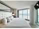 Bright main bedroom featuring a king bed, accent mirror, and ocean views at 107 S Ocean Blvd. # 808, Myrtle Beach, SC 29577