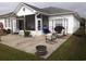 Spacious backyard with patio, outdoor seating, and well-maintained lawn at 237 Cloverleaf Dr., Longs, SC 29568
