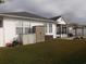 Backyard with white fence, outdoor storage units, and patio furniture at 237 Cloverleaf Dr., Longs, SC 29568
