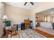 Sunlit bonus room featuring an antique desk, rocking chair, and seamless transition to the main bedroom at 237 Cloverleaf Dr., Longs, SC 29568