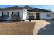 Charming single-story home featuring a two-car garage and welcoming rocking chairs on the front porch at 237 Cloverleaf Dr., Longs, SC 29568
