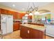 Well-equipped kitchen with a center island, granite countertops, and cherry-colored cabinetry at 237 Cloverleaf Dr., Longs, SC 29568
