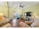Comfortable living room featuring hardwood floors, ceiling fan and sliding glass door to porch at 237 Cloverleaf Dr., Longs, SC 29568