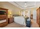 Comfortable main bedroom with a king bed, ceiling fan, and wooden furniture providing ample storage space at 237 Cloverleaf Dr., Longs, SC 29568