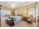 Comfortable main bedroom with a king bed, tray ceiling, fan and lots of natural light from two windows at 237 Cloverleaf Dr., Longs, SC 29568