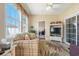 Relaxing sun room with large windows, a comfortable couch, and access to the outdoors through a sliding door at 237 Cloverleaf Dr., Longs, SC 29568