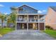 Two-story home with blue siding, a wrap-around porch, and a spacious driveway at 508 21St Ave. N, North Myrtle Beach, SC 29582