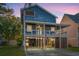Two-story home with blue siding, a wrap-around porch, and a spacious driveway at dusk at 508 21St Ave. N, North Myrtle Beach, SC 29582