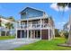 Two-story home with blue siding, a wrap-around porch, and a spacious driveway at 508 21St Ave. N, North Myrtle Beach, SC 29582