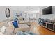 Spacious living room with sectional sofa, hardwood floors, and large TV at 508 21St Ave. N, North Myrtle Beach, SC 29582