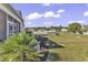 Landscaped backyard with pond view and walkway at 217 Southern Breezes Circle, Murrells Inlet, SC 29576