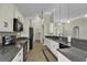 Modern kitchen with granite countertops, white cabinets, and black appliances at 217 Southern Breezes Circle, Murrells Inlet, SC 29576