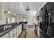 Kitchen features granite countertops, white cabinets, and black appliances at 217 Southern Breezes Circle, Murrells Inlet, SC 29576