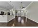 Open living area with hardwood floors and a view of the kitchen at 217 Southern Breezes Circle, Murrells Inlet, SC 29576