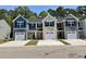 New townhomes boast attached garages, colorful doors, and modern exterior finishes at 259 Christiana Ln. # E, Myrtle Beach, SC 29579