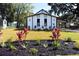 Charming home with a white exterior, black trim, well-maintained lawn, and lovely landscaping at 37 Geney Ln., Pawleys Island, SC 29585