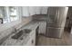 Bright kitchen with stone countertops, stainless steel appliances, and white shaker cabinets at 37 Geney Ln., Pawleys Island, SC 29585