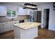 Well-lit kitchen featuring stainless steel appliances, granite countertops, and bright white cabinetry at 37 Geney Ln., Pawleys Island, SC 29585