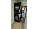 Modern laundry area features sleek, dark appliances and convenient storage at 37 Geney Ln., Pawleys Island, SC 29585