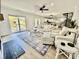 Bright living room boasts hardwood floors, neutral furniture, and a water view from the sliding glass door at 37 Geney Ln., Pawleys Island, SC 29585