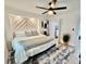 Well-lit main bedroom features a decorative headboard, rug, and a ceiling fan at 37 Geney Ln., Pawleys Island, SC 29585