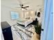 Well-lit main bedroom boasts a decorative headboard, rug, ceiling fan, and neutral color palette at 37 Geney Ln., Pawleys Island, SC 29585