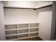 Spacious walk-in closet with new vinyl flooring and built in shelving to organize your wardrobe at 37 Geney Ln., Pawleys Island, SC 29585