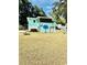 Spacious backyard with a palm tree mural, hot tub, fire pit, and ample green space at 3936 Murrells Inlet Rd., Murrells Inlet, SC 29576