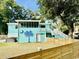 Expansive backyard with a palm tree mural, wooden fence, and a hot tub for relaxation at 3936 Murrells Inlet Rd., Murrells Inlet, SC 29576