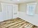 Bright bedroom with luxury vinyl floors, built-in shelving, and a window with natural light at 3936 Murrells Inlet Rd., Murrells Inlet, SC 29576