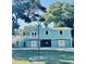 Charming two-story home with aqua siding, white trim, and a well-manicured front yard at 3936 Murrells Inlet Rd., Murrells Inlet, SC 29576