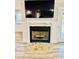 Beautiful fireplace with a stone hearth and a mounted television, perfect for cozy evenings at 3936 Murrells Inlet Rd., Murrells Inlet, SC 29576